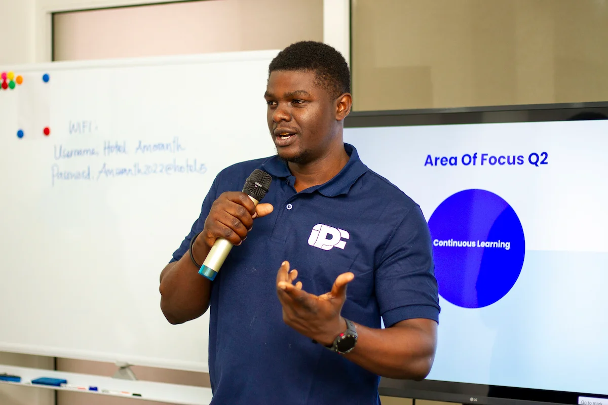 Boniface Kato Baraka presenting to colleagues about quarterly focus areas and continuous learning